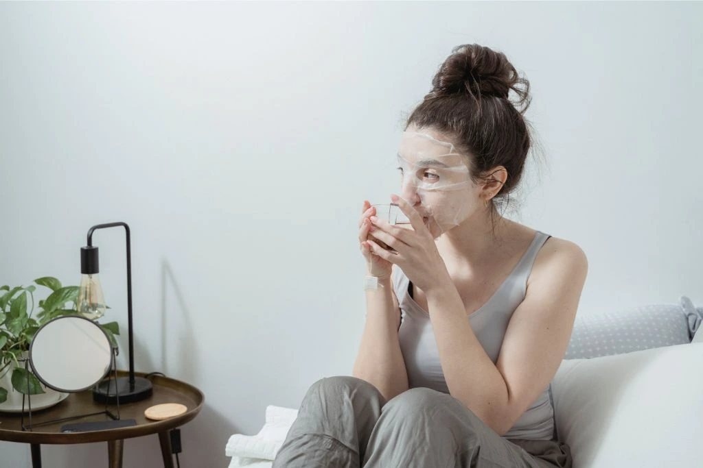 woman drinking tea on her couch
