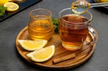 honey tea with lemon poured on two glass jars