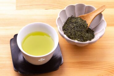 sencha tea prepared on a white small jar glass