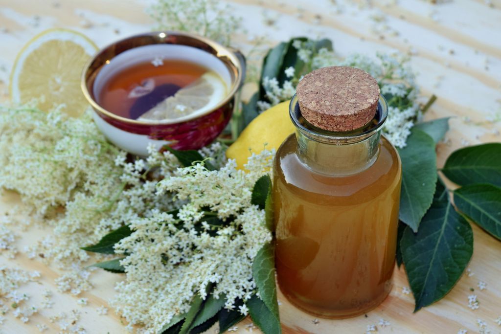 honey and elderberry tea with lemon placed in a table