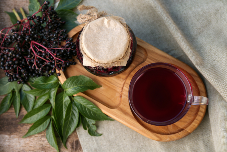 elderberry tea and honey in a wooden coaster