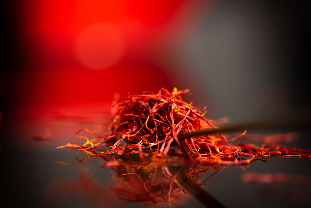 saffron threads on a red black gradient background
