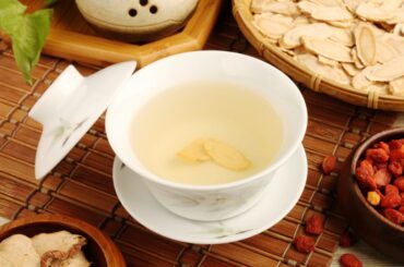 a cup of traditional ginseng tea and herbs