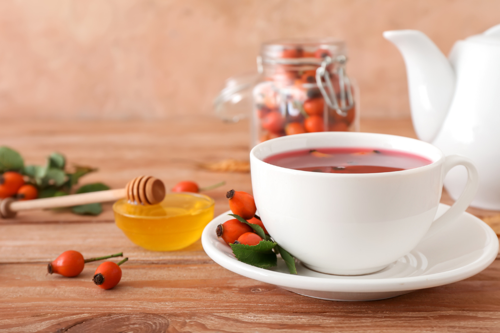 rose hip tea cup with honey beside