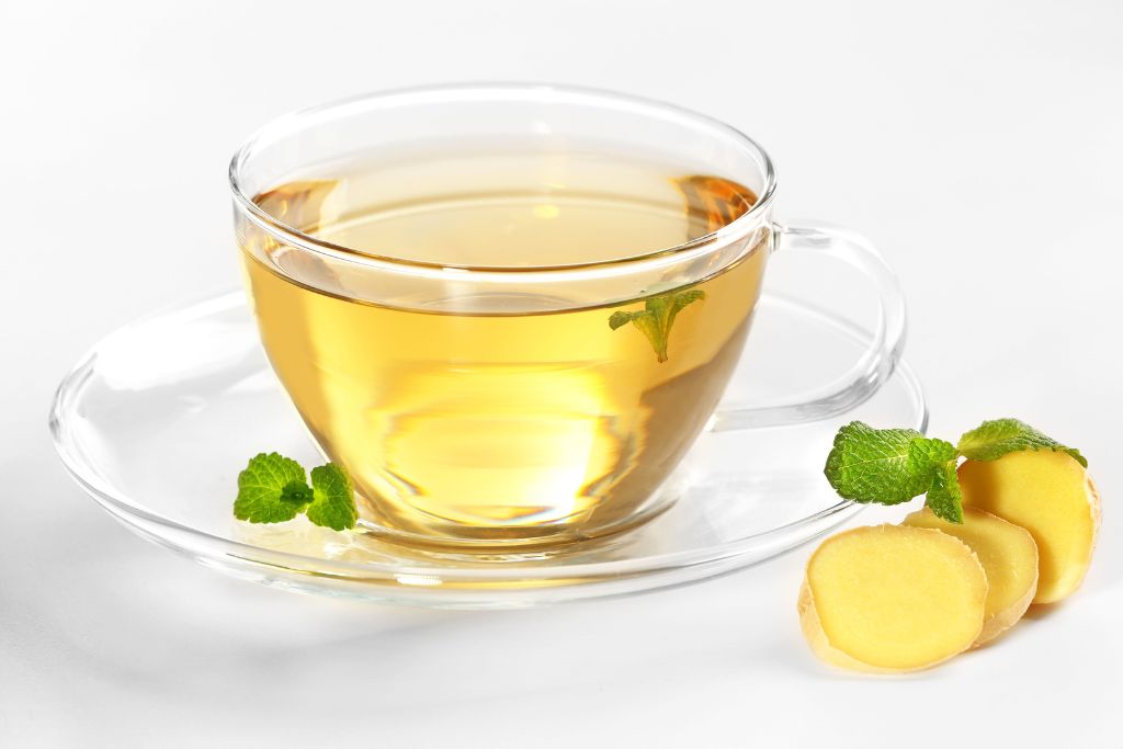a cup of ginger mint tea on a white background
