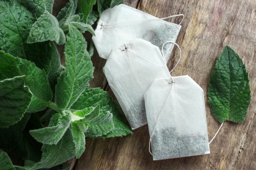 mint and tea bags on wood table