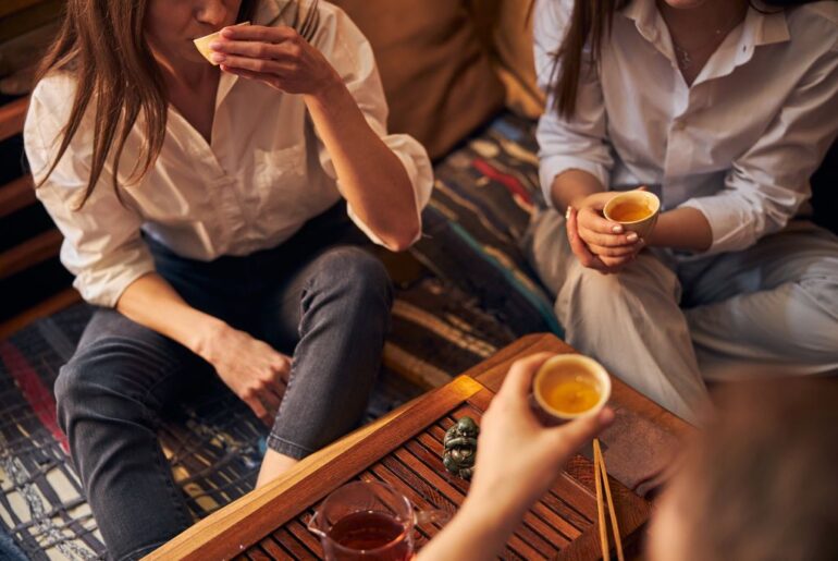 3 female models holding a cup of tea