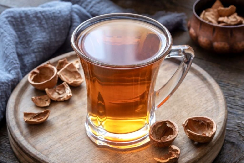 walnut tea with shells on a round wood tray