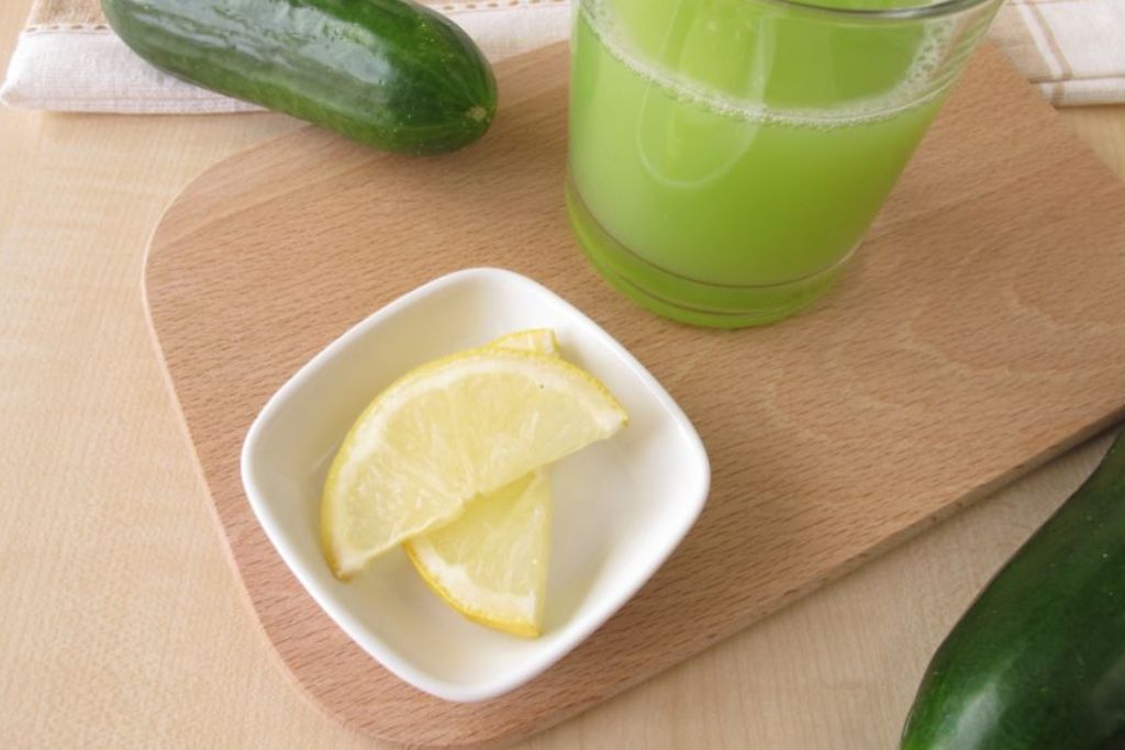 fresh cucumber with sliced lemon on a table