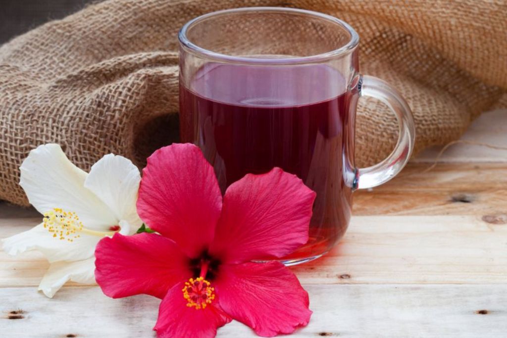 hibiscus tea and hibiscus flower on a brown sack jute background