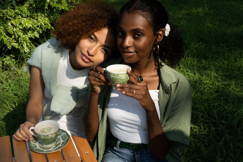 two diverse women drinking matcha outdoors